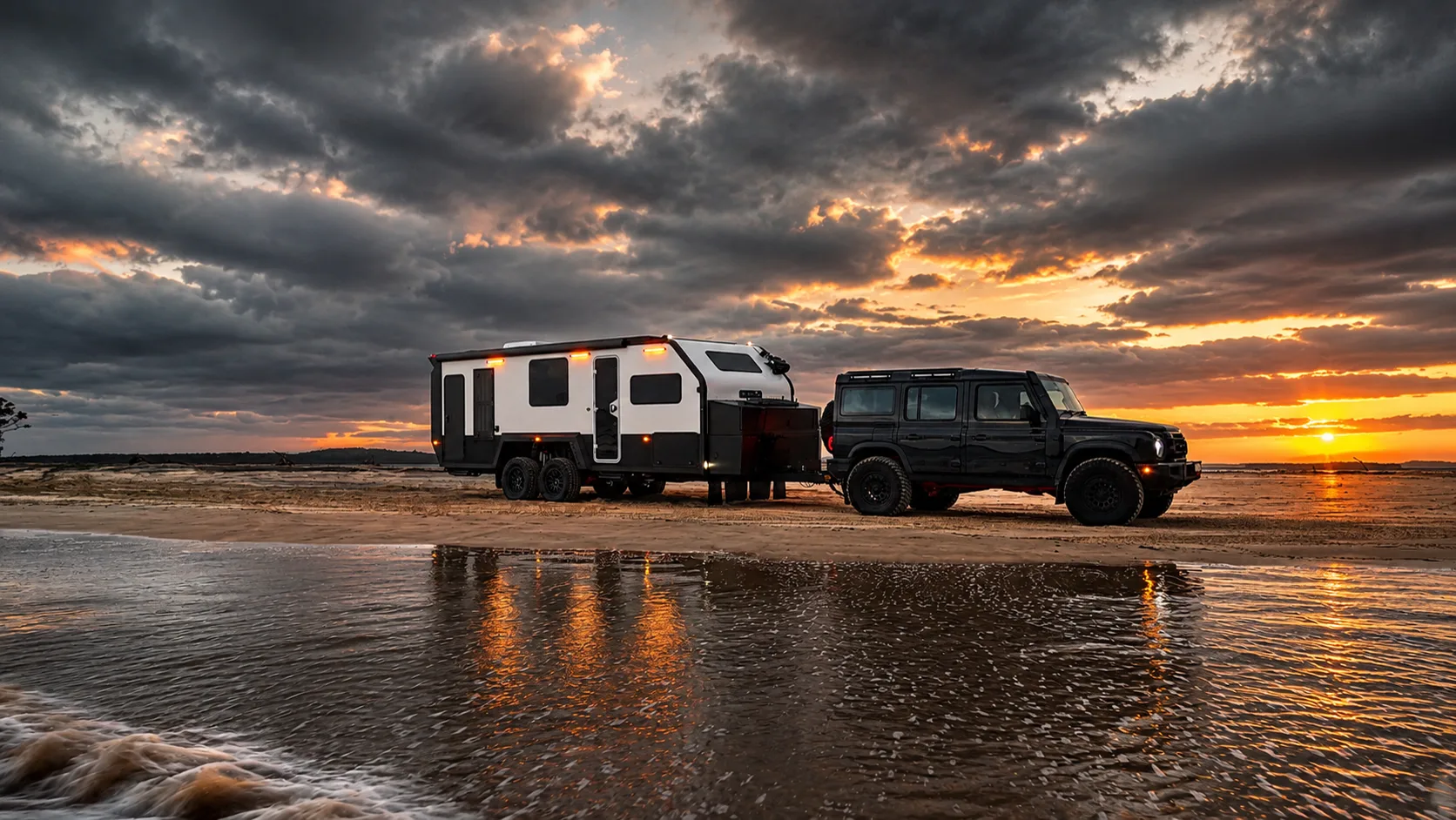 A Bruder expedition trailer hitched to a 4WD, overlooking the water at golden hour
